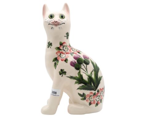 A Griselda Hill Wemyss model of a cat, decorated with thistles, clover and dog roses with green glass eyes Condition Report:A