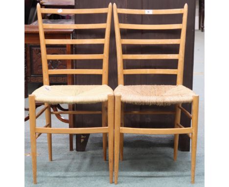 A pair of Italian beech framed ladder back chairs in the manner of Gio Ponti with rushed seats on turned tapering supports jo