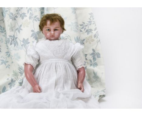 A Pierotti poured wax doll circa 1880, With head turned slightly to the right, pale blue eyes, deep brows, inset light brown 