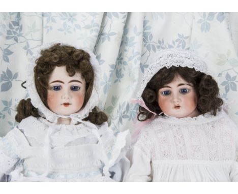 Two large German bisque shoulder-head dolls, A Heinrich Handwerck 1900 with fixed blue glass eyes —25½in. (65cm.) high; and L