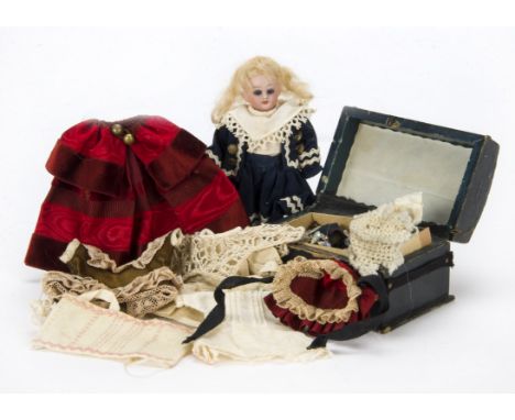 A German dolls’ house doll with trousseau, With blue sleeping eyes, blonde mohair wig, composition body and blue sailor’s dre