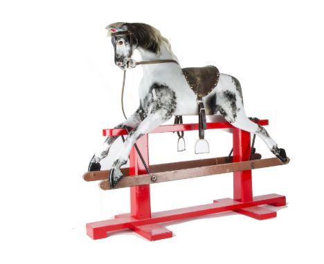 A carved and painted wooden rocking horse,  With glass eyes and trestle rocker —44½in. (113cm.) long (completely repainted)