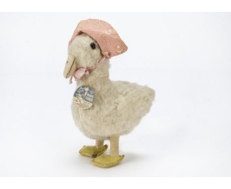 A Chad Valley Pantomime Magic Goose soft toy, With white wool plush, orange and black glass eyes, felt beak and feet, pink pr