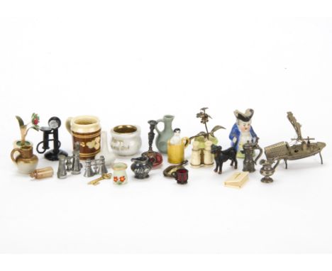 Dolls’ house miniatures, A glass flower pot with metal flowers, a lead dog, a stick telephone, a Toby Jug, cracker charms and