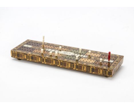 A fine Tonbridge Ware cribbage board,  With Masonic compass symbol and various pegs —13in. (33cm.) long