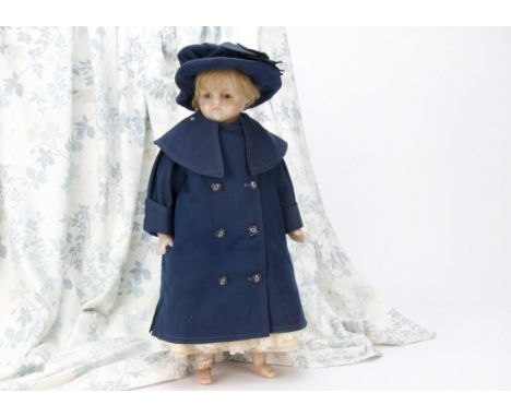 A late 19th Century English poured wax child doll, With head turned slightly to the right, large blue striated glass eyes, fe