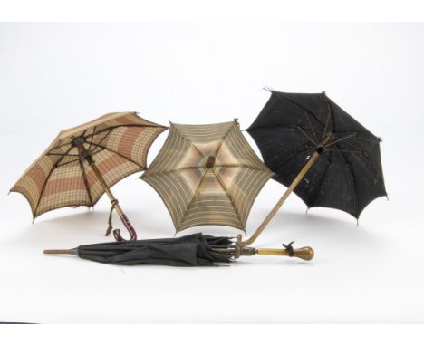 Four doll’s umbrellas, Two with patterned material, wooden stick with celluloid handle —8½in. (21.5cm.) larger; and two black