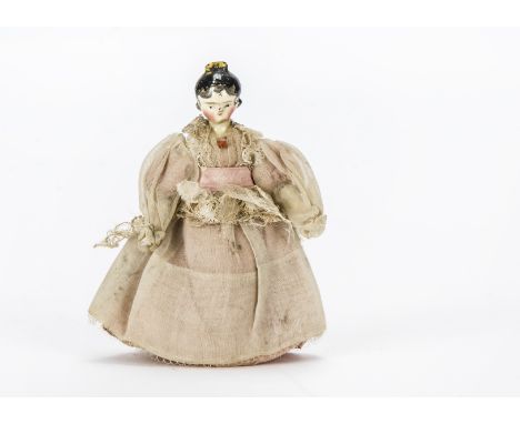 A Grodnerthal dolls’ house doll, Carved and painted wood with black painted hair with curls falling onto face, yellow comb, j