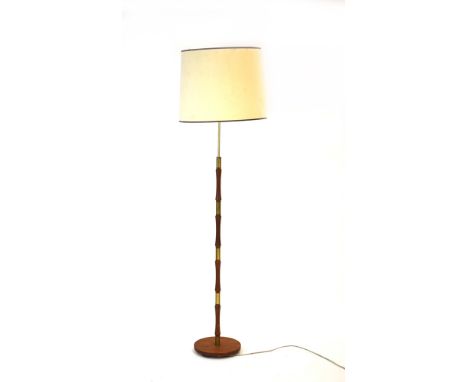 A 1960's turned teak and brass segmented standard lamp with cream shade CONDITION REPORT: Working order unknown. Lead cut. Sh