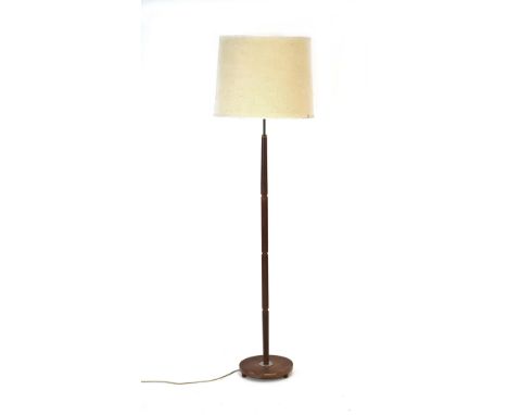 A 1960's turned teak and brass standard lamp with cream shade CONDITION REPORT: Working order unknown. Lead cut. Shade dented
