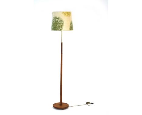 A 1960's turned teak faux bamboo standard lamp with cream floral patterned shade CONDITION REPORT: Working order unknown. Lea