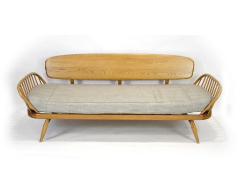 Lucien Ercolini for Ercol, an elm and beech sofa bed with a 'surfboard' back*Sold subject to our soft furnishings policy http