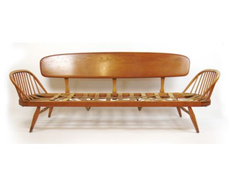 Lucien Ercolini for Ercol, an elm and beech sofa bed with a 'surfboard' back*Sold subject to our soft furnishings policy http