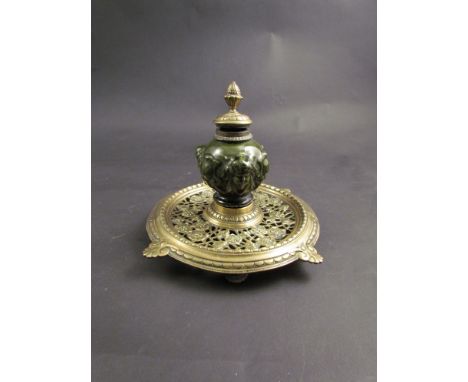 A Victorian and ceramic inkwell with putti head decoration