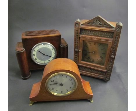 Two oak mantel clocks and a small Edwardian mahogany and inlaid clock with brass feet and bezel 