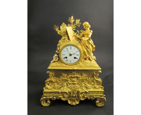 A 19th Century French gilt on bronze figural clock, Roman numerated dial with 8 day movement striking on a bell, the base wit