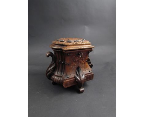 A Victorian mahogany carved tea caddy (with key)