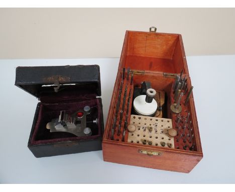 A cased watchmaker's poising tool and a case of tools