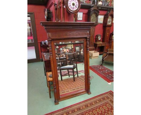 A 19th Century carved oak pier mirror with bevelled edge and turned columns, 152 x 99cm with surround 