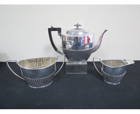 A silver plated three piece tea service, fluted lower half 