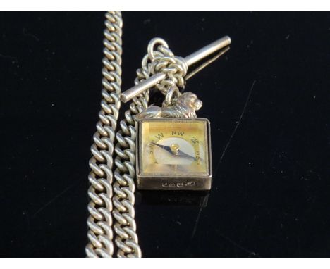 A silver watch chain with T-bar and compass