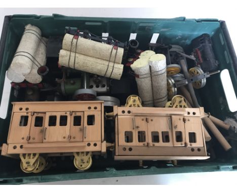 A box of steam related items, including a tractor engine, roller,O gauge  locomotive along with a lumber trailer, wooden trai