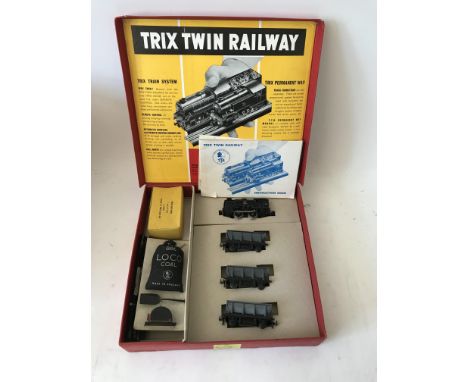 Included are 3 boxed trix twin railway sets. The first set is a contains locomotive, 3 metal wagons, and coal accessories. Th