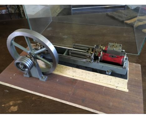 A scratch built single piston , flywheel, beam engine, housed in glass case