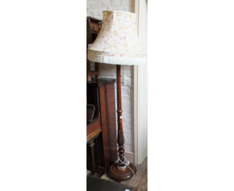 A carved Mahogany standard lamp
