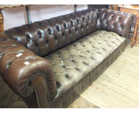 A brown leather button back Chesterfield settee, length 84"