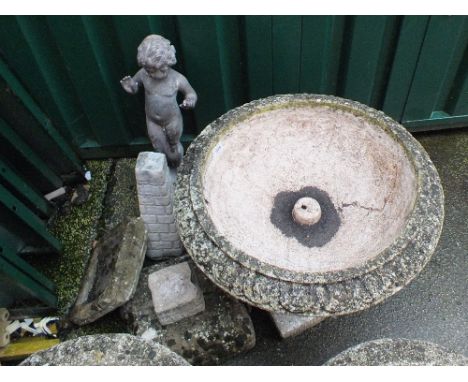 A large weathered concrete planter and a statue of a boy etc