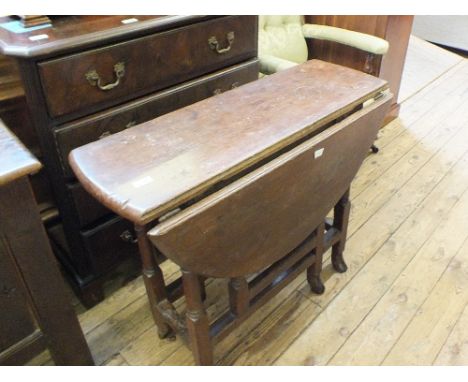 An 18th Century oval Oak gate leg table on turned legs