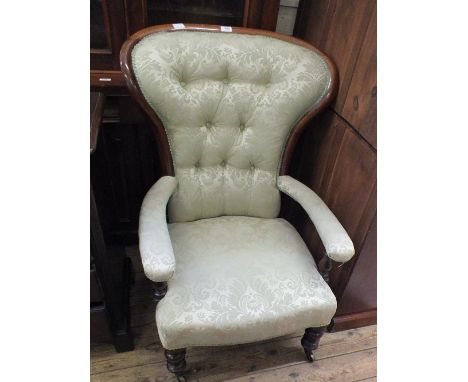 A Victorian Mahogany pronounced spoon back armchair with light green button back upholstery on turned legs