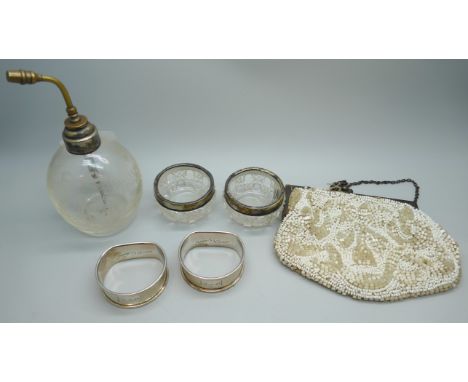 Two silver napkin rings, 22g, two silver rimmed salts, an atomiser with silver collar, and a beadwork purse