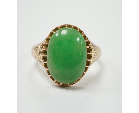 A yellow metal (stamped 18) and single stone cabochon jade set ring, size Q, gross weight 5.7 grams.