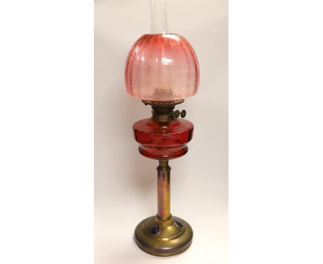 19th century brass oil lamp with cranberry glass reservoir, etched shade and Ruskin type cabochon panels to the base, 68cm ho