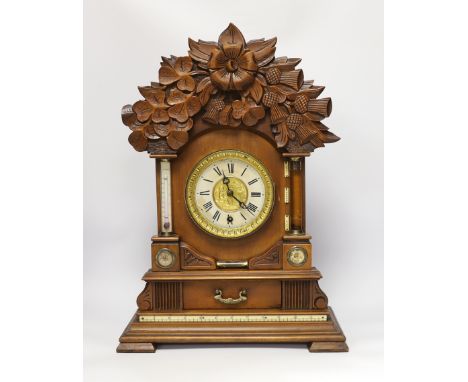 A carved wood clock with barometer, thermometer and compass, 52cm high