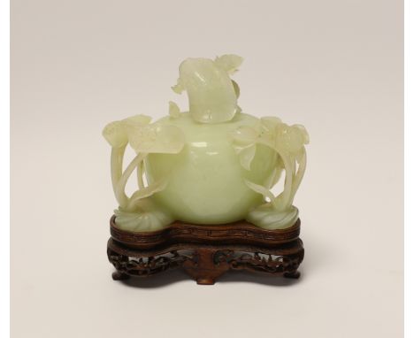 A Chinese carved bowenite jade ‘lotus’ water pot  and cover on hardwood stand, 13cm