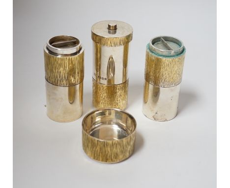 A suite of four Elizabeth II parcel gilt silver condiments, comprising a cylindrical salt, pepper and pepper grinder and a tu