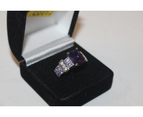 A costume ring set with purple stones 