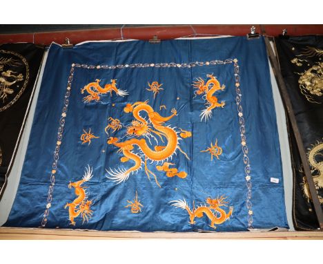 A Chinese blue silk embroidery with orange dragon and flaming pearl decoration