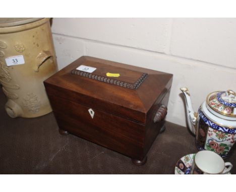 A 19th Century mahogany sarcophagus shaped two compartment tea caddy 