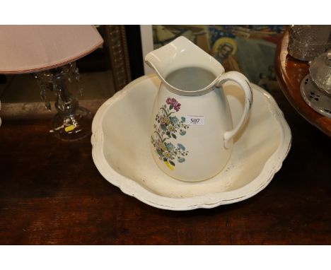 A floral decorated toilet jug and a large wash basin with gilt boarder decoration 