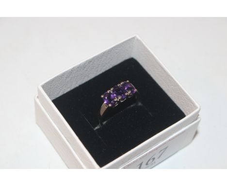 A Sterling silver and amethyst three stone ring, size R/S