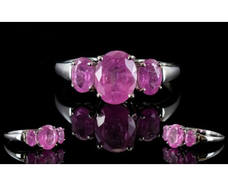 Pink Sapphire Three Stone Ring, a central oval cut pink sapphire of 2.25cts, flanked by two further oval cuts totalling 1.25c