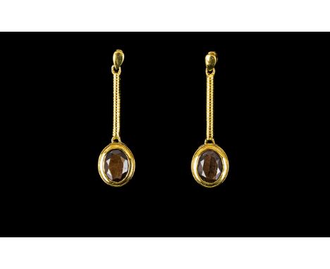 Golden Lustre Sapphire Drop Earrings, 5cts over two oval cut solitaires of the natural golden lustre sapphire, bezel set in 1