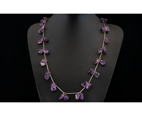 A Vintage Amethyst Necklace Long pewter tone necklace set with multiple, organic form polished amethyst stones between elonga