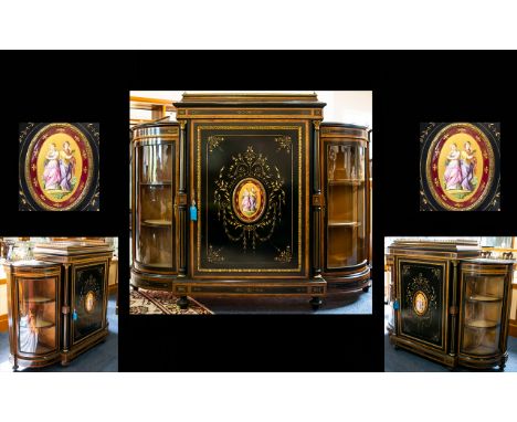 A Victorian Walnut And Ebonised Credenza Of typical form with ormolu gallery top , the central door with painted oval Sevres 