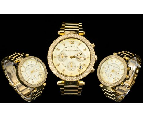 Michael Kors Stylish MK 5354 Ladies Parker Chronograph Watch. Features Gold Plated Stainless Steel Bracelet with a Diamante E