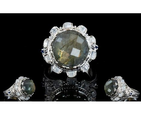 Labradorite and Rainbow Moonstone Statement Ring, with sapphire accents; an 11ct chequerboard faceted, round cut labradorite,